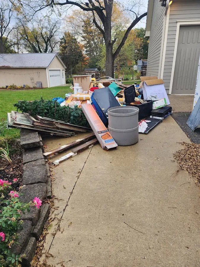 Dumpster being loaded with debris for 12 Yard Dumpster Rental in Tacoma
